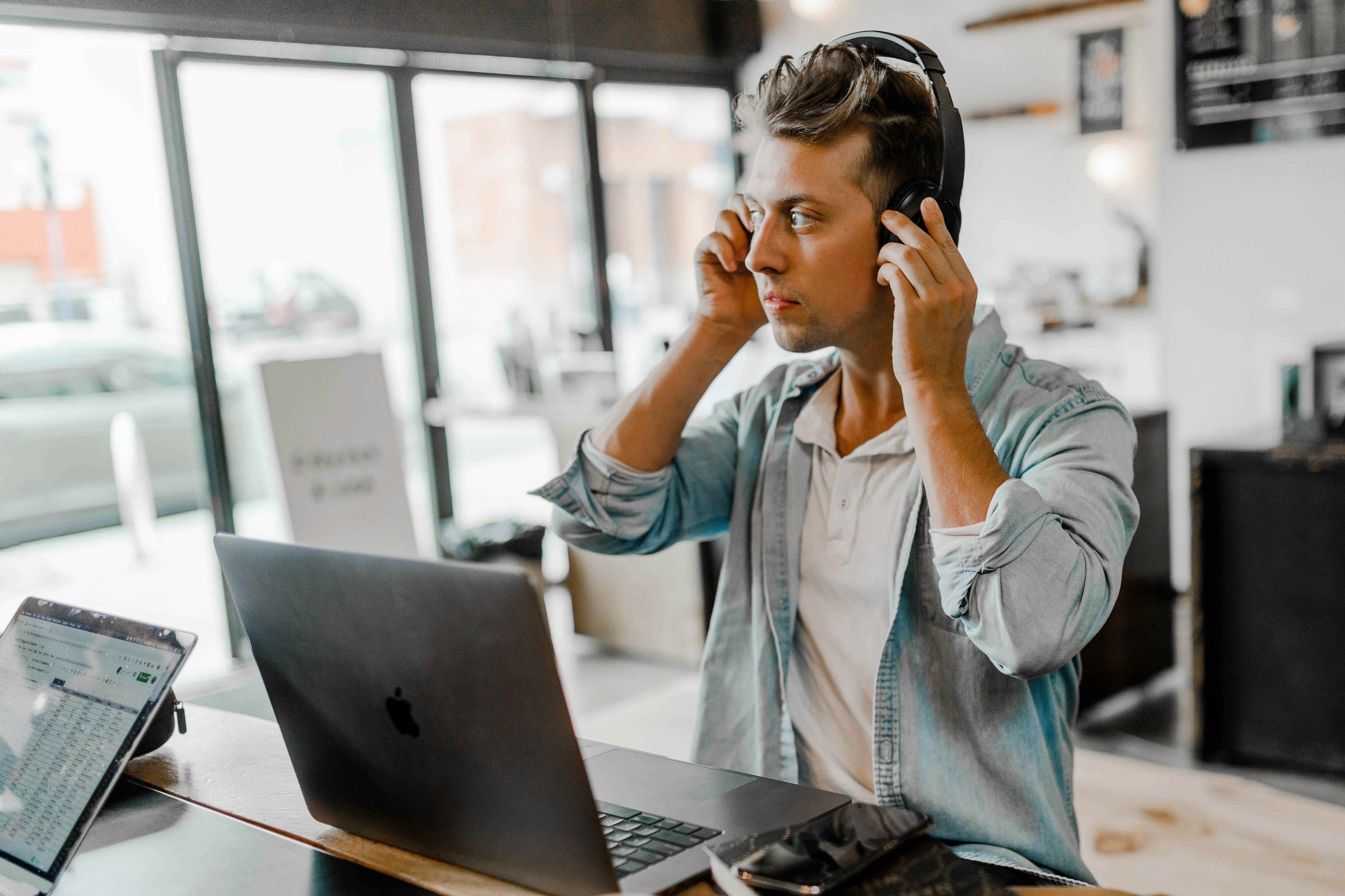 man putting on headphones