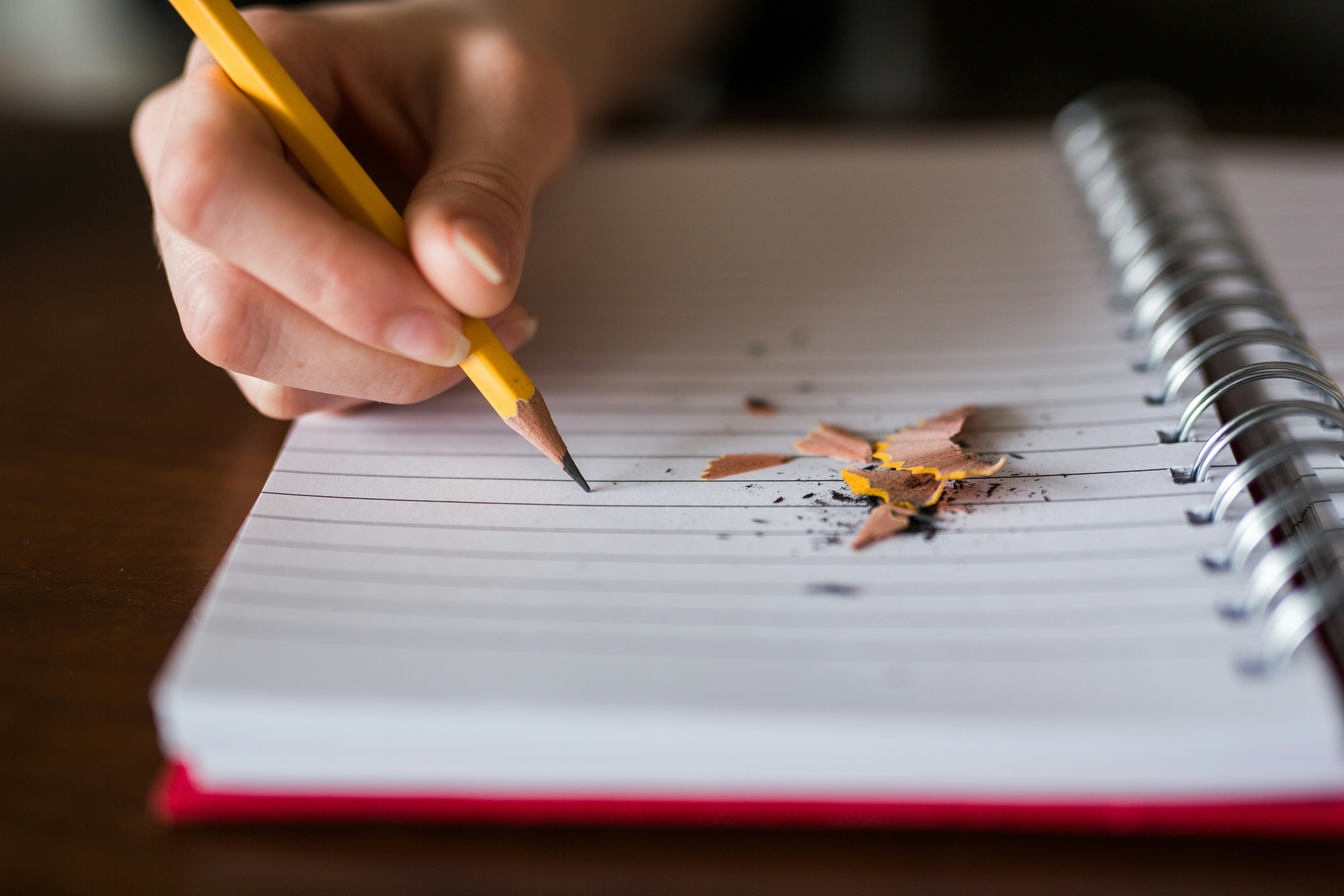 broken pencil writing in notebook