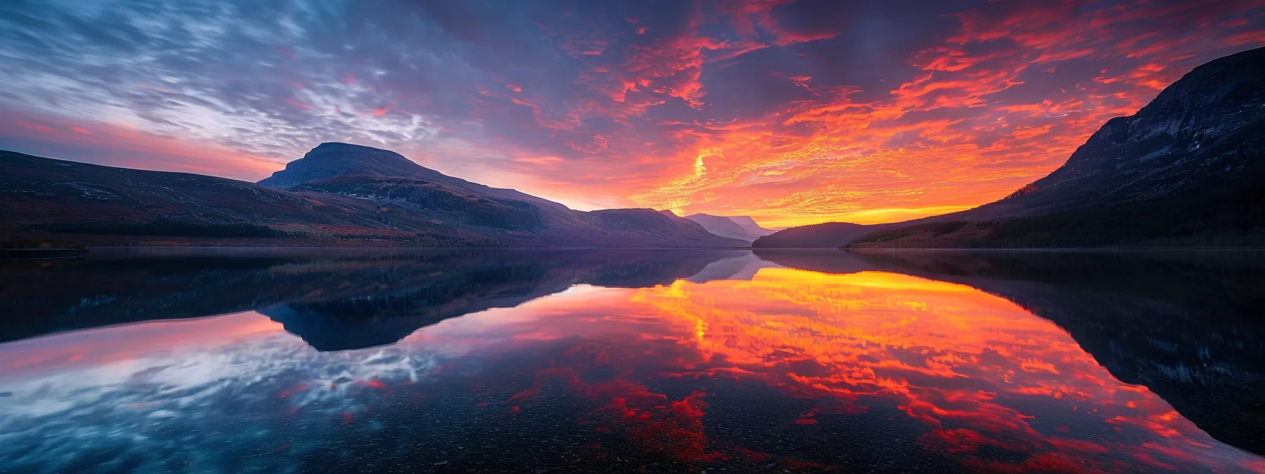 a breathtaking sunrise illuminates a serene mountain landscape, casting vibrant hues of orange and pink across the sky while reflecting on a tranquil lake below.