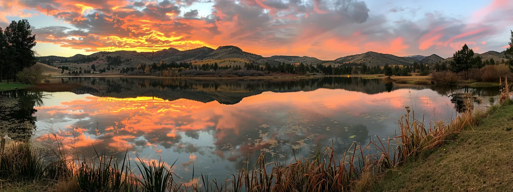 a breathtaking sunset casts a golden glow over a tranquil lake, surrounded by majestic mountains, reflecting vibrant hues of orange and pink in the still water.