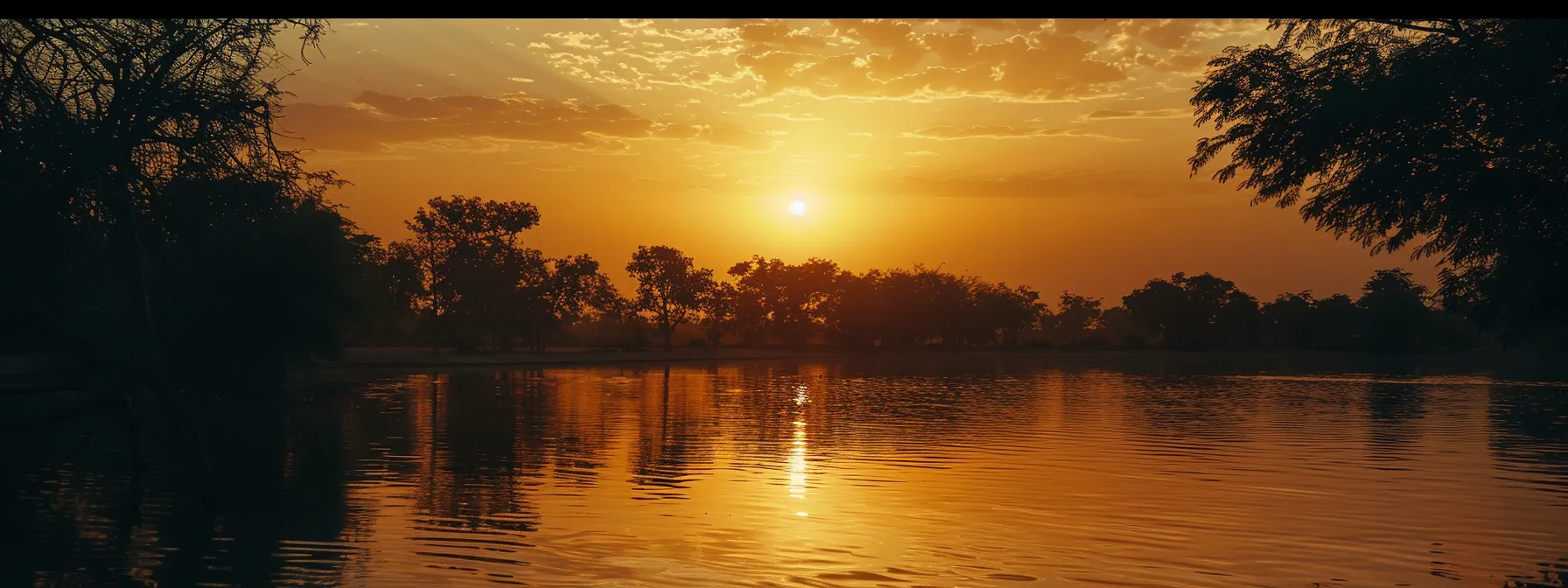 a brilliant sunset casts golden hues over a serene lake, reflecting the vibrant colors of the sky while silhouetted trees frame the tranquil scene, evoking a sense of peace and wonder.