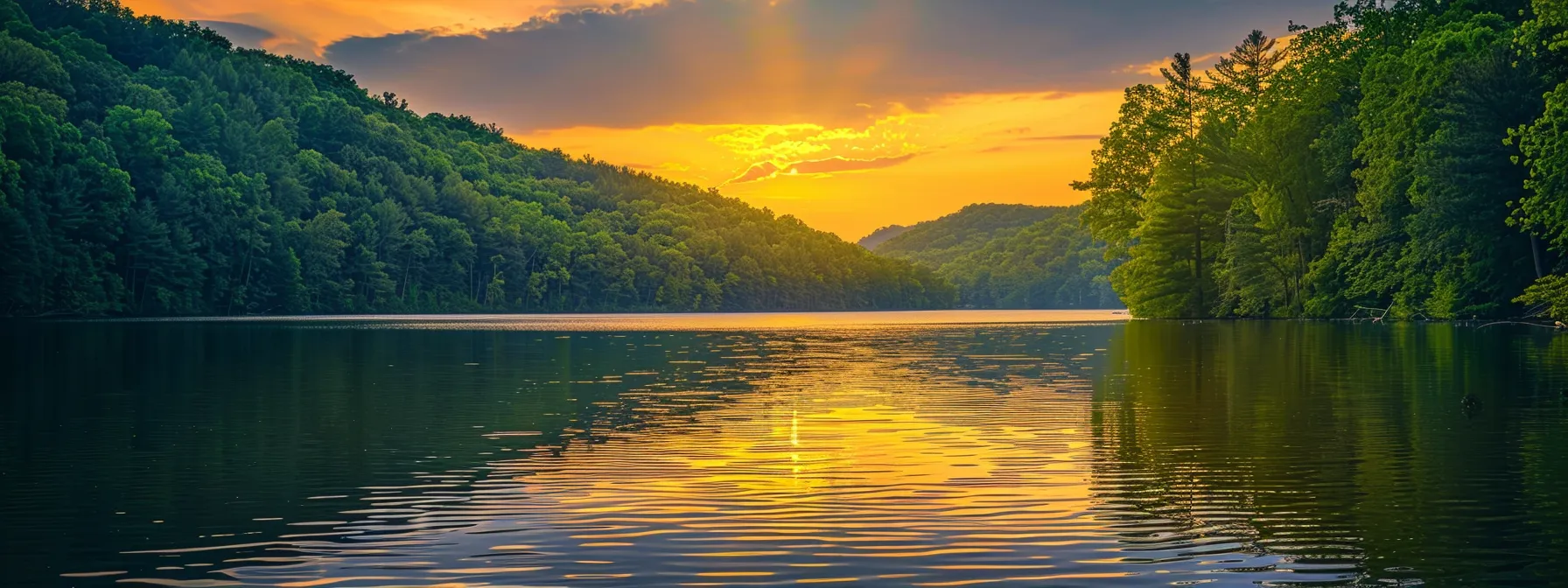 a serene landscape captures a golden sunset spilling warm hues over a tranquil lake, framed by lush, emerald-green trees, reflecting the vibrant colors in the water's surface.
