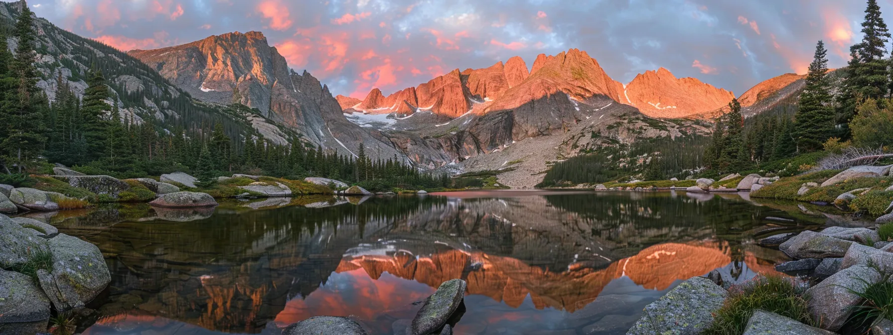 a serene mountain sunrise bathes the rugged peaks in golden light, reflecting off a tranquil lake surrounded by lush evergreen forests.