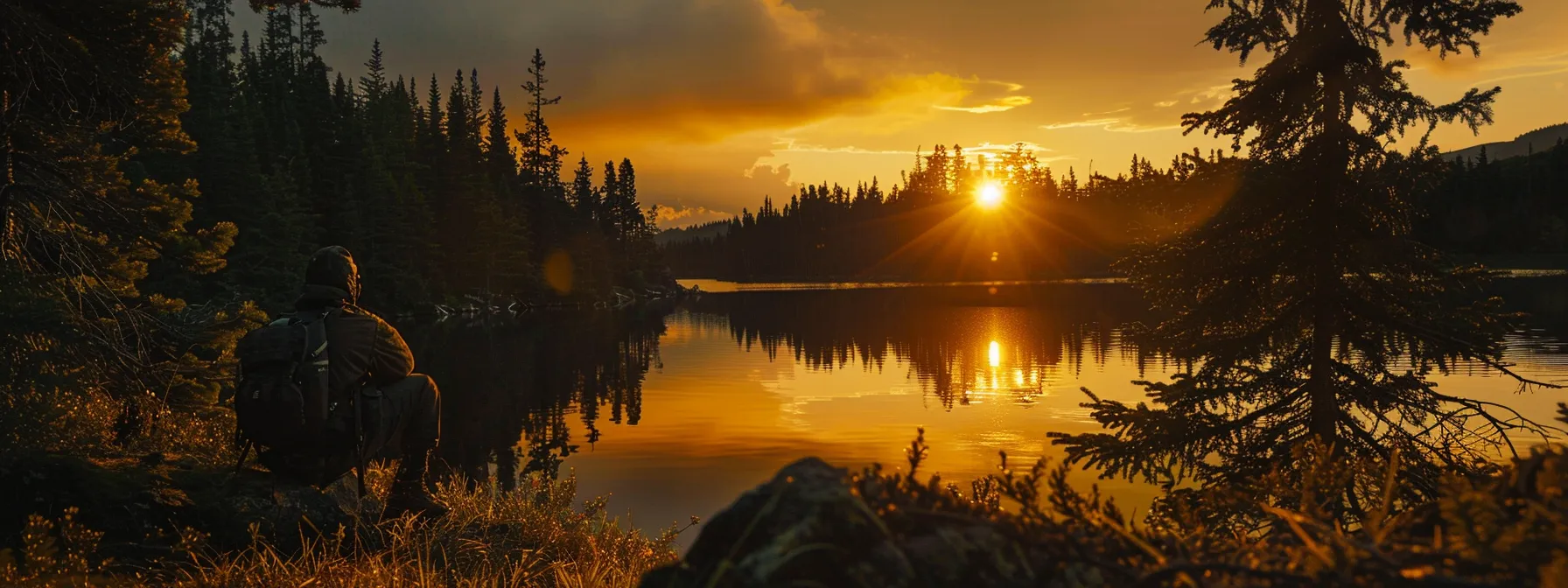 a vibrant sunset casts a warm golden glow over a serene lake, with silhouetted trees framing the scene, evoking a sense of tranquility and harmony in nature.