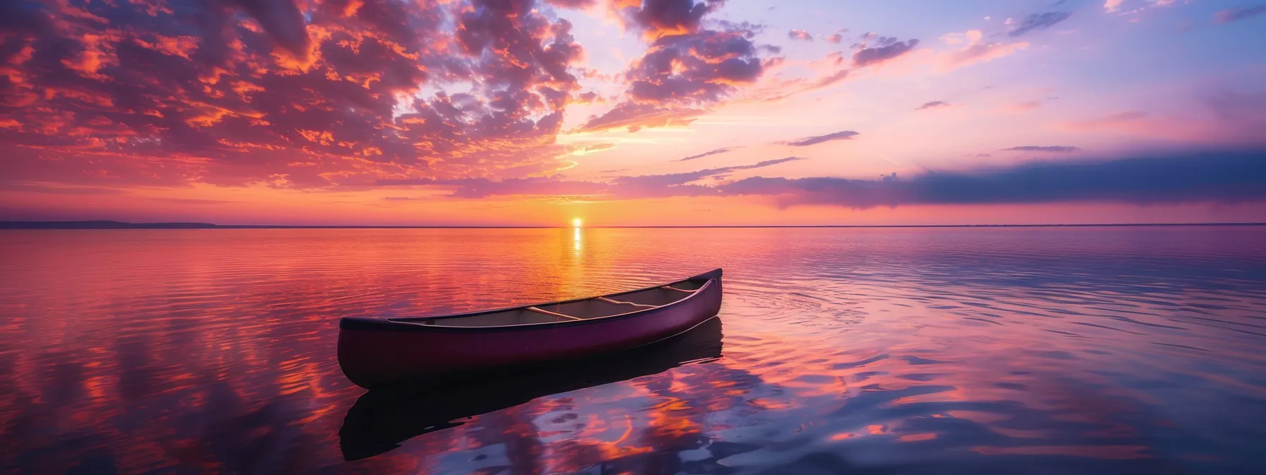 a vibrant sunset casts a warm glow over a serene lake, where a solitary canoe drifts peacefully amidst the reflections of colorful clouds above.