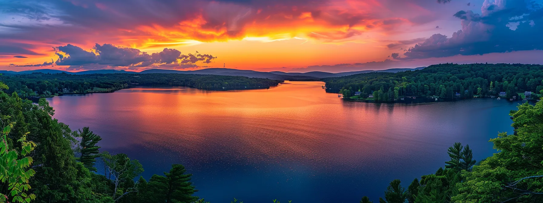 a vibrant sunset casts a warm golden glow over a tranquil lake, reflecting the fiery sky and surrounding lush greenery, creating a striking contrast of colors and serenity.