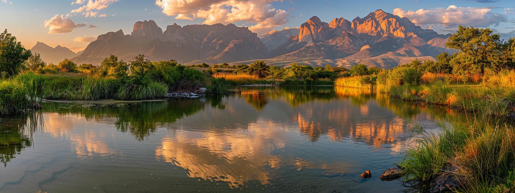 a vibrant sunset casts a warm golden glow over a tranquil lake, where majestic mountains rise in the background, reflecting their rugged peaks on the still water's surface.