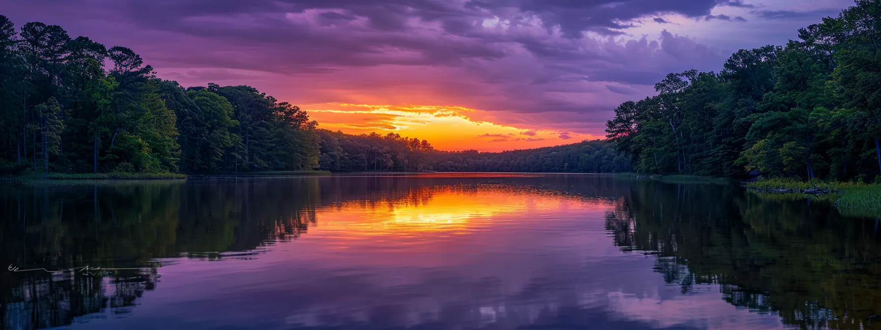 a vibrant sunset paints the sky in a spectrum of orange and purple hues, reflecting off the calm waters of a serene lake surrounded by lush greenery.
