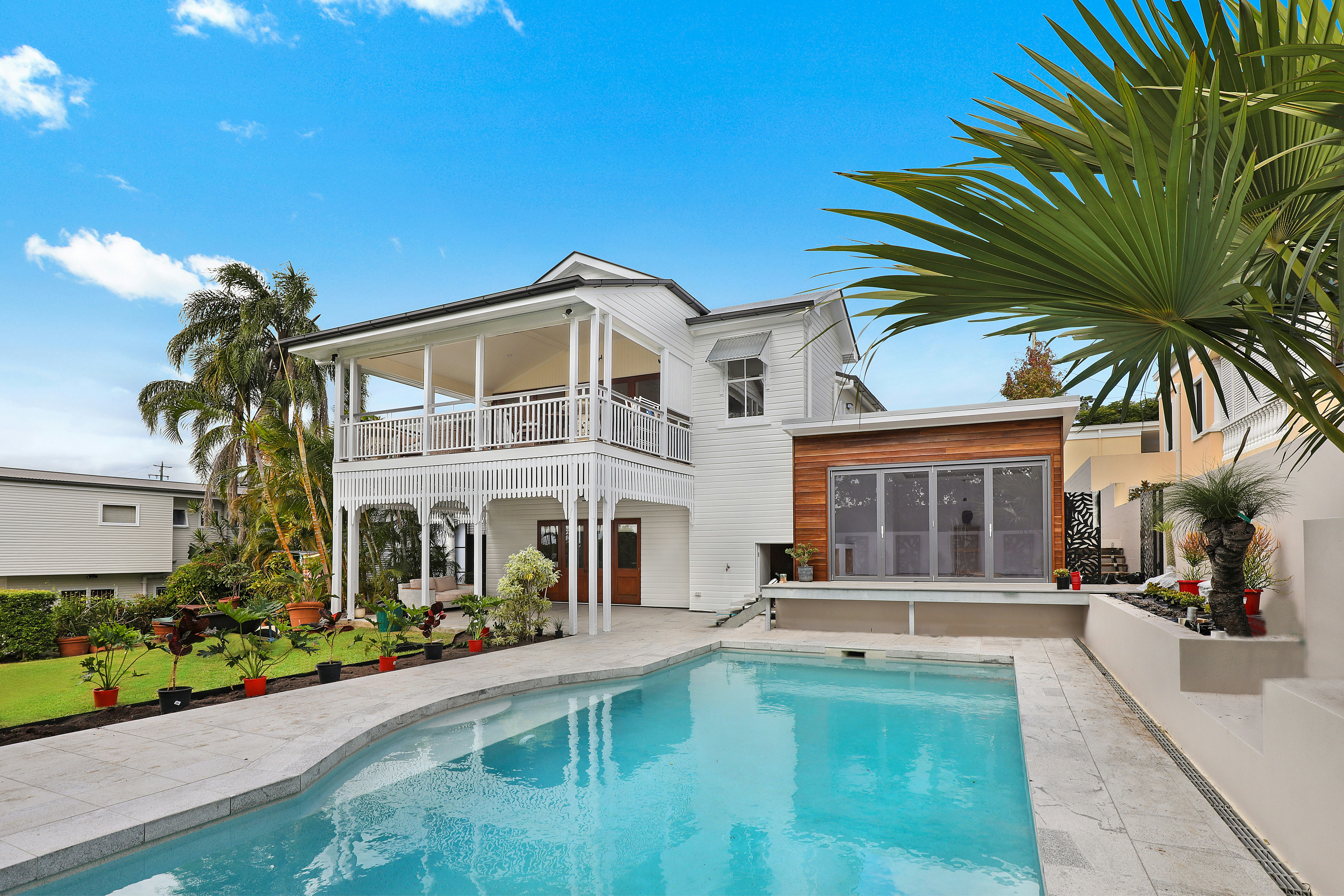 white home with a pool in backyard