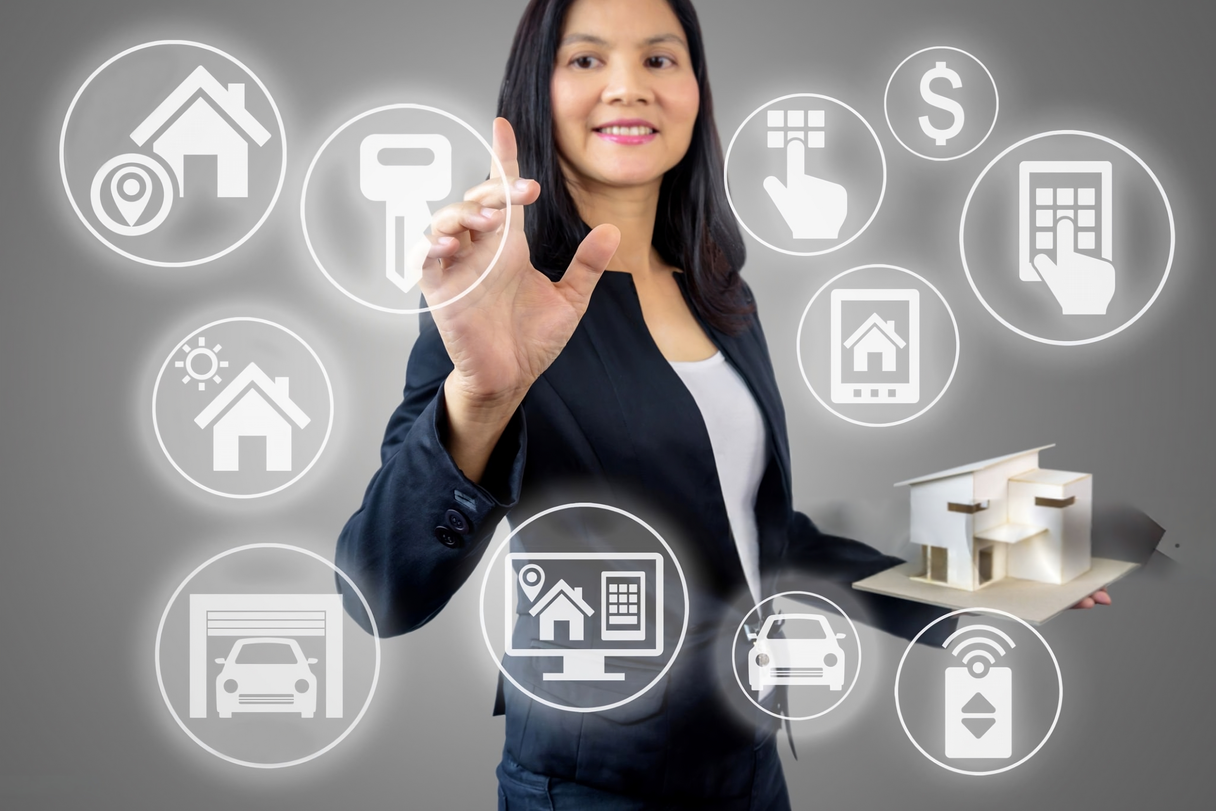 Real estate technology concept with a businesswoman interacting with smart property icons in a virtual interface